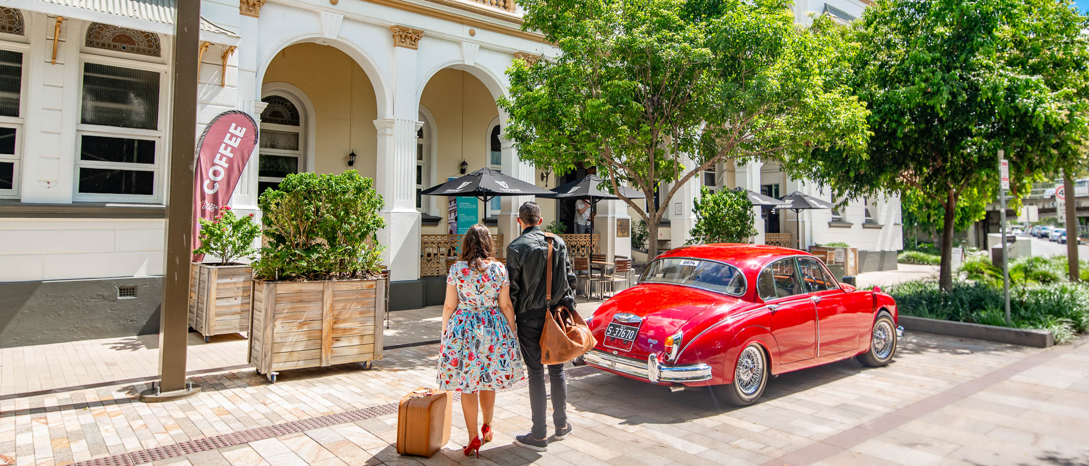 Classic car unloading luggage at accommodation - Criterion Hotel