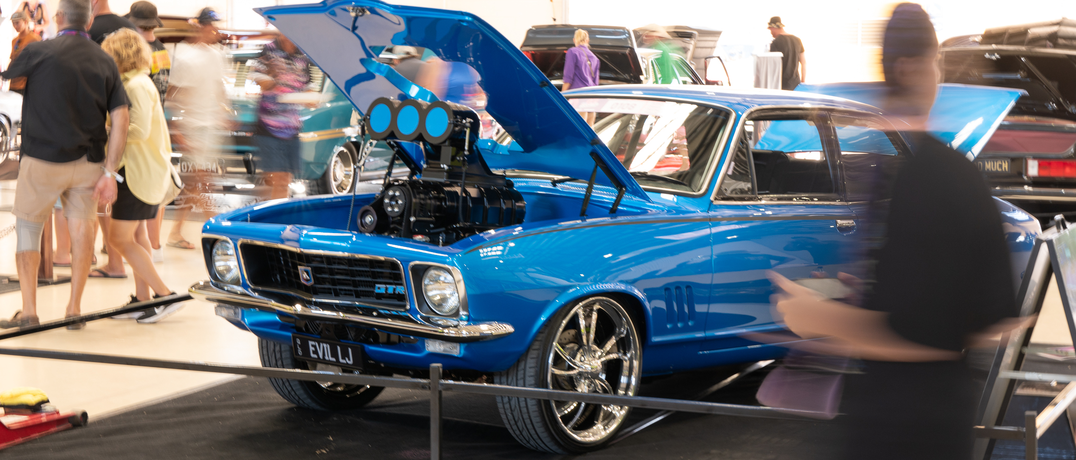 People looking at cars on display at the Rockynats Elite Section