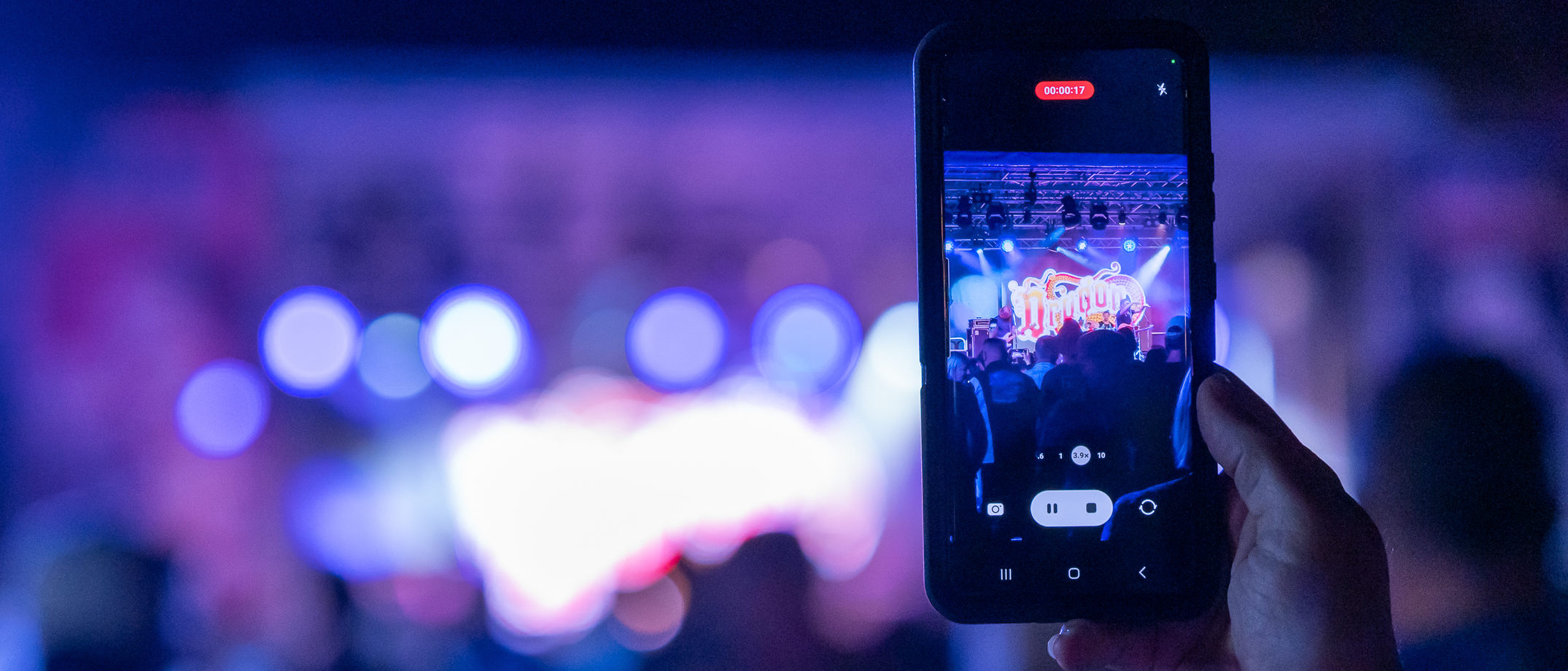 Person watching Dragon perform live on stage at Rockynats in the Showgrounds precinct