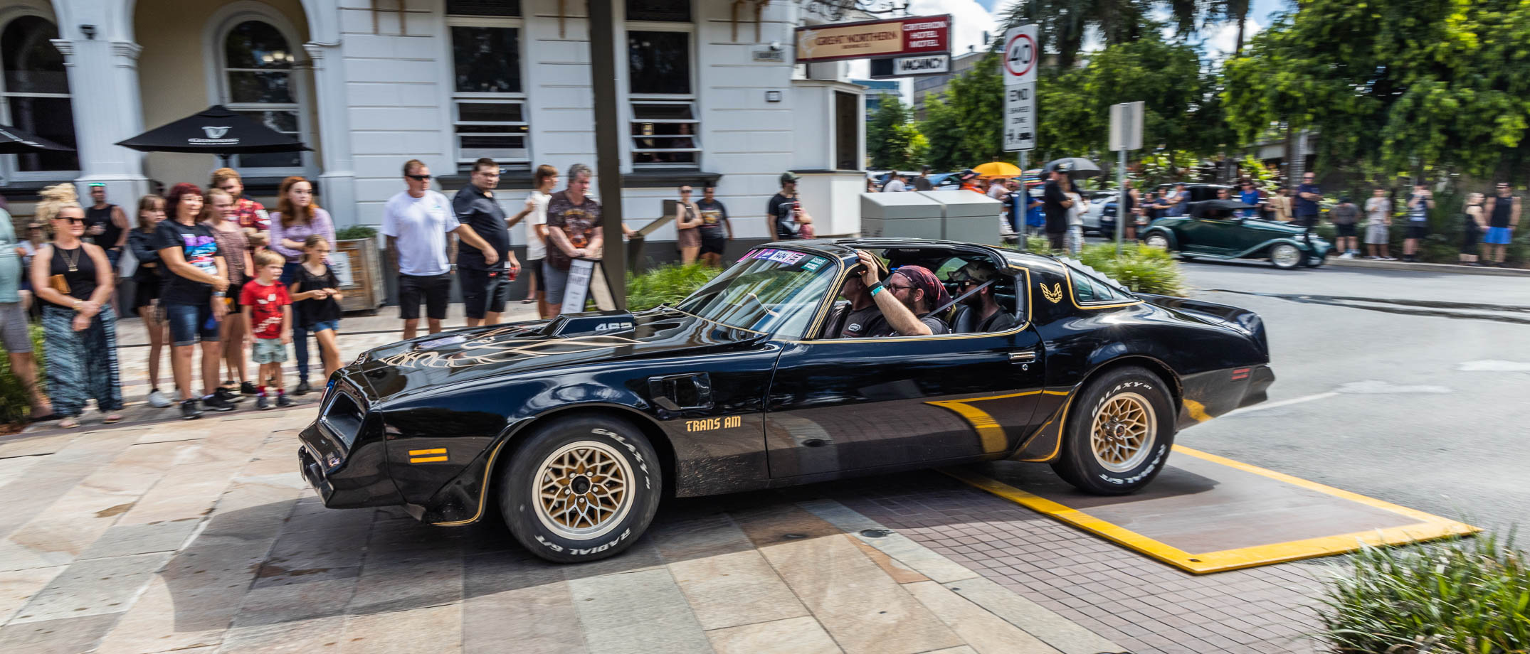 Trans Am driving on Quay Street in Rockynats Street Parade with crowd in background