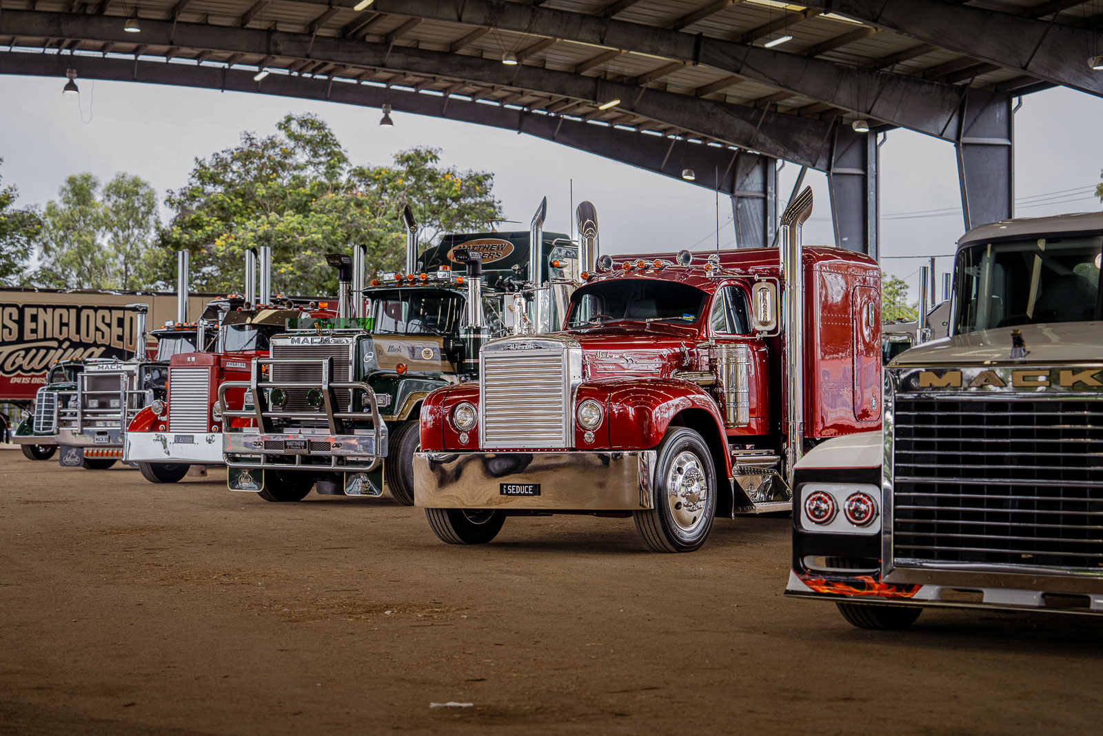 A row of big trucks under the Robert Schwarten Pavilion at Rockynats