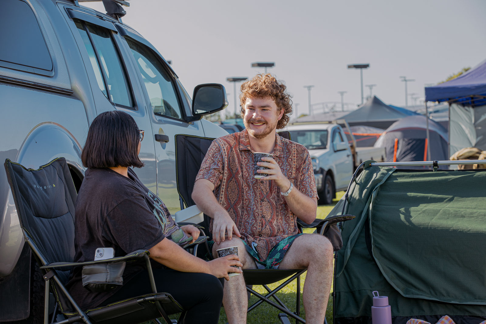 Two people having a coffee early at the Rockynats campground